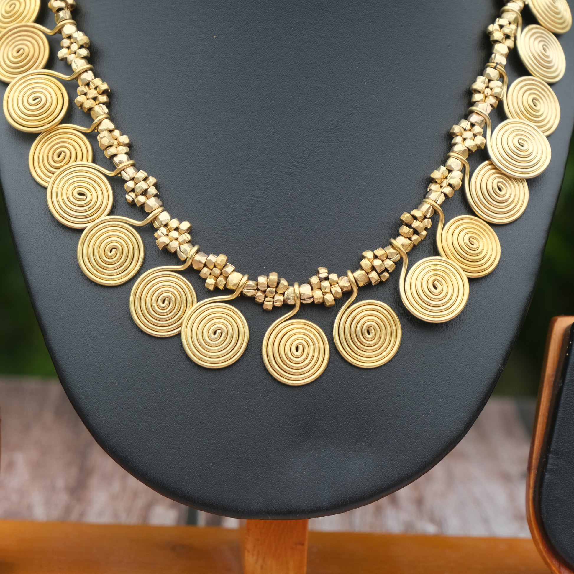 Handcrafted Dhokra golden beaded necklace featuring a circular design; ethically made by Odisha artisans using ancient lost-wax casting. A sustainable everyday statement piece for white linen shirts or tunics by KalaKart