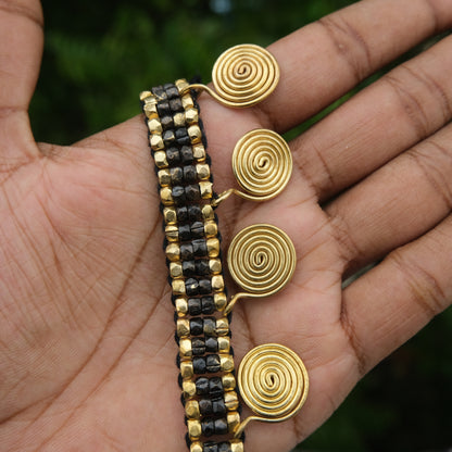 Handcrafted Golden and black Dhokra beaded necklace with a tribal design; ethically made by Odisha artisans using ancient lost-wax casting. A sustainable festive statement piece for handloom sarees by KalaKart.