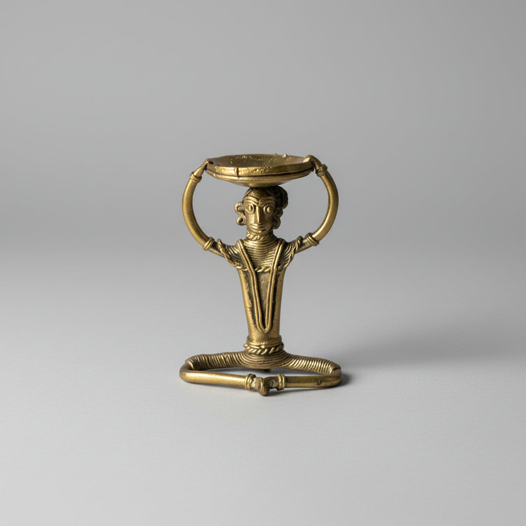 A handmade dhokra craft handmade brass diya holder having a tribal figurine