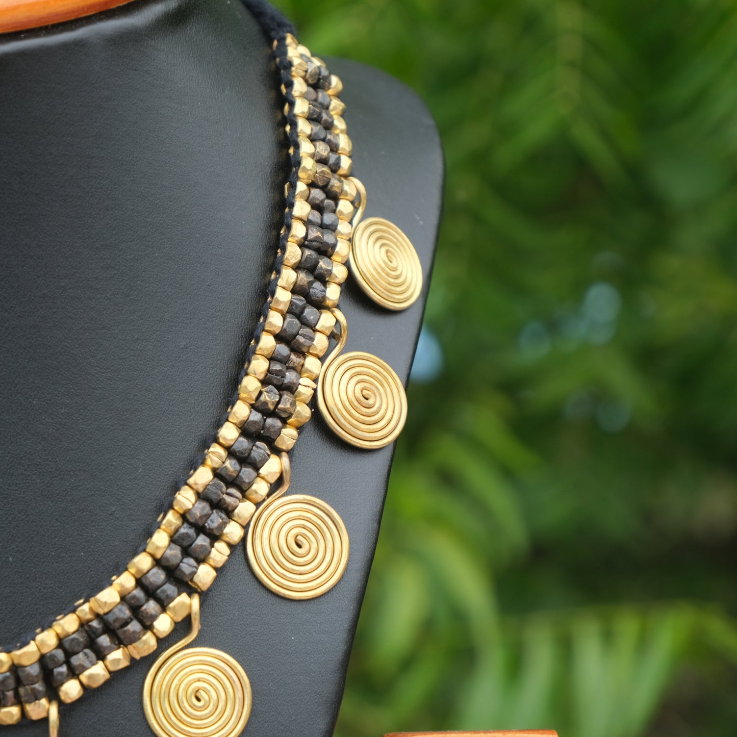 Handcrafted Golden and black Dhokra beaded necklace with a tribal design; ethically made by Odisha artisans using ancient lost-wax casting. A sustainable festive statement piece for handloom sarees by KalaKart.