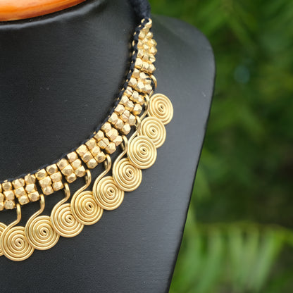 Handcrafted Golden Dhokra beaded necklace with a tribal design; ethically made by Odisha artisans using ancient lost-wax casting. A sustainable festive statement piece for handloom sarees by KalaKart.