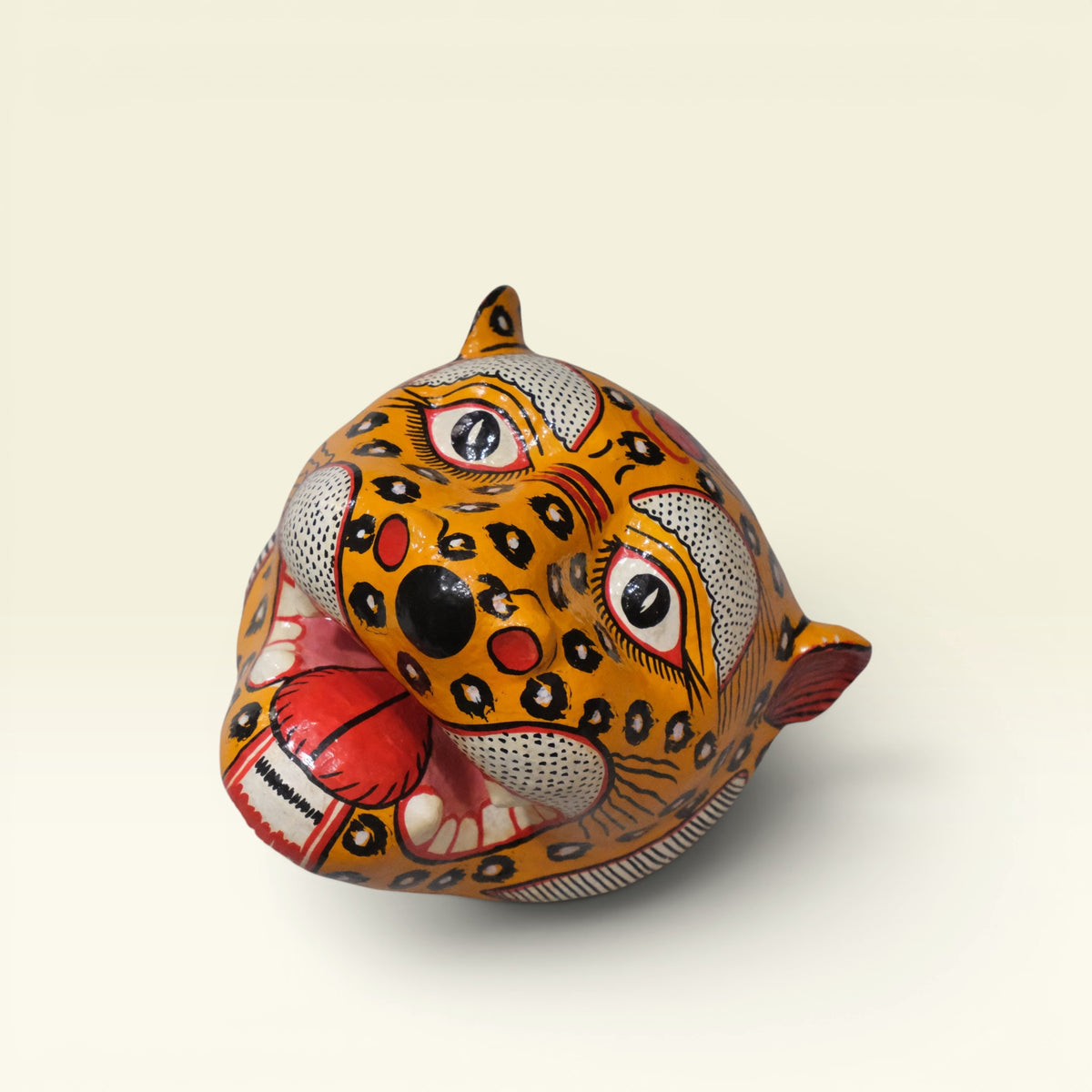 Handcrafted yellow and black hand-painted Pattachitra papier-mache tiger mask from Odisha featuring open jaws and intricate motif details