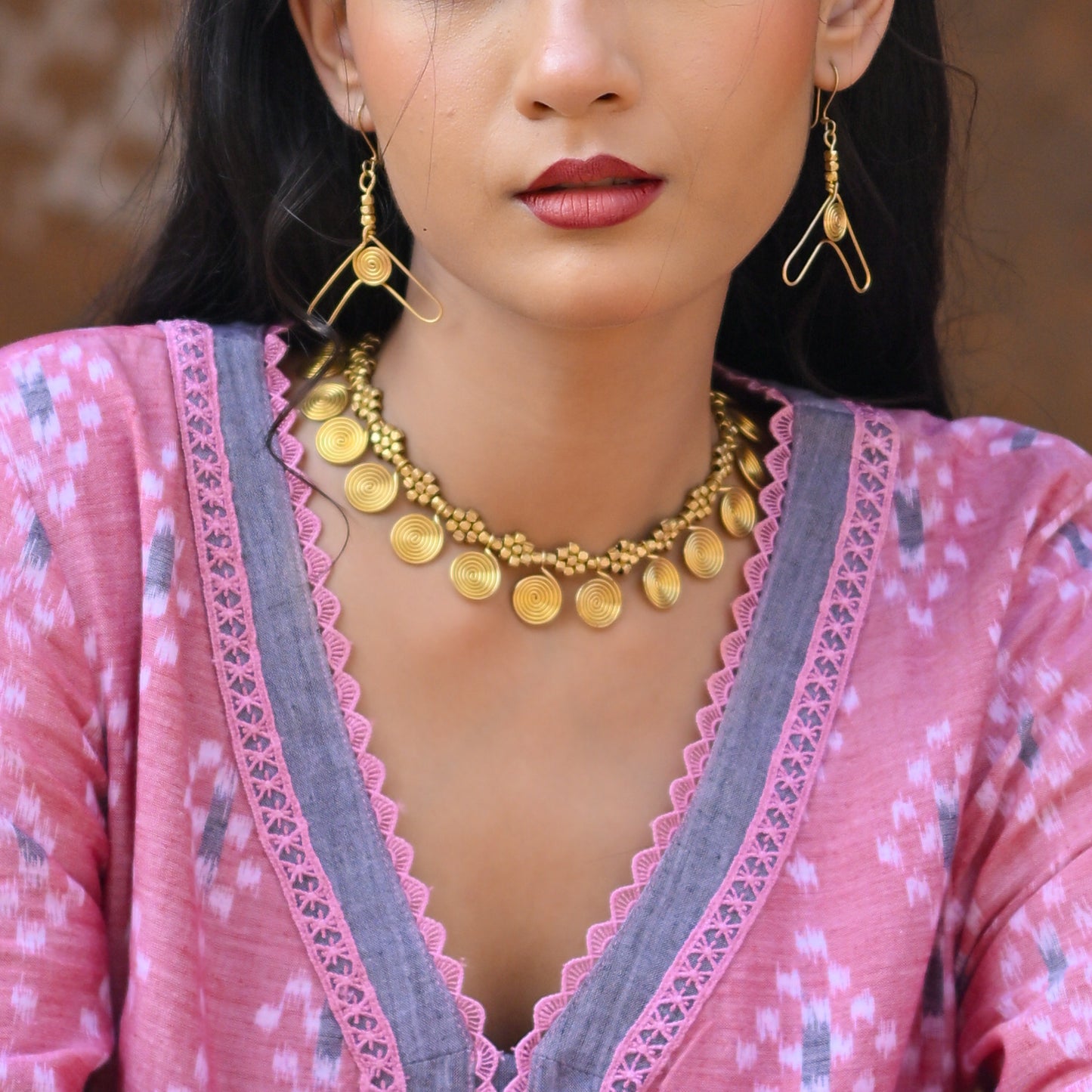 Handcrafted Dhokra golden beaded necklace featuring a circular design; ethically made by Odisha artisans using ancient lost-wax casting. A sustainable everyday statement piece for white linen shirts or tunics by KalaKart