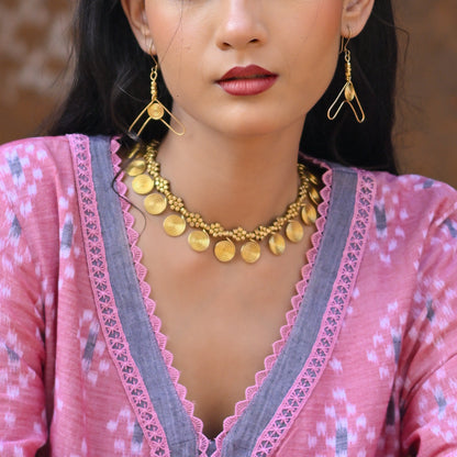 Handcrafted Dhokra golden beaded necklace featuring a circular design; ethically made by Odisha artisans using ancient lost-wax casting. A sustainable everyday statement piece for white linen shirts or tunics by KalaKart